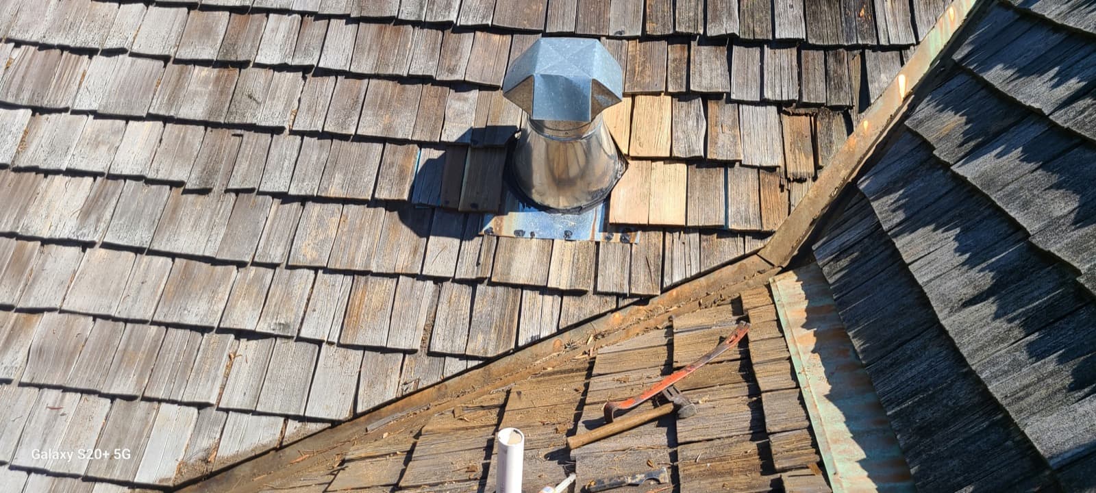 Cedar shake roof flashing detail around vent and valley transitions