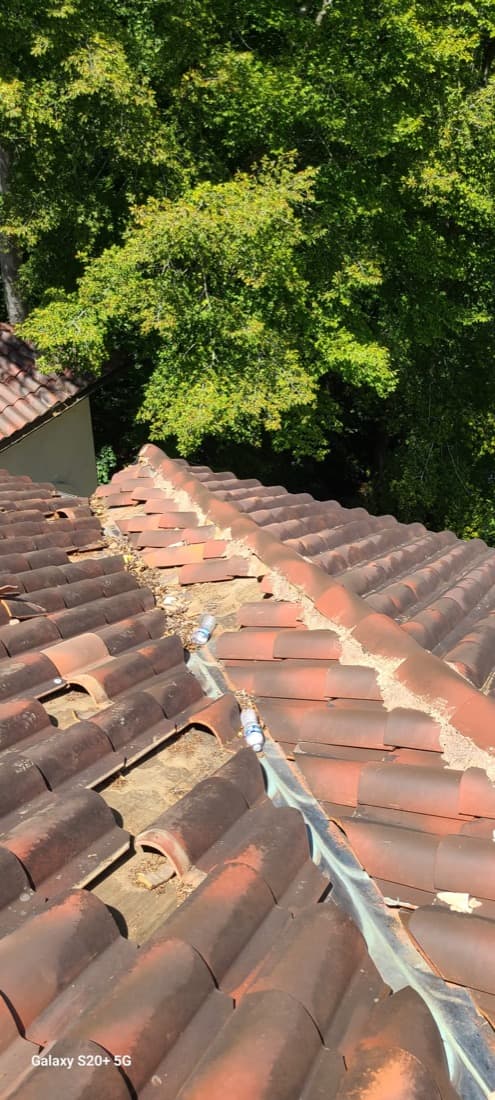 Spanish clay tile ridge repair with mortar and runoff detail
